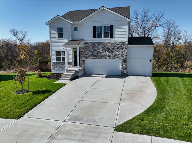 front of property featuring a front yard and a garage