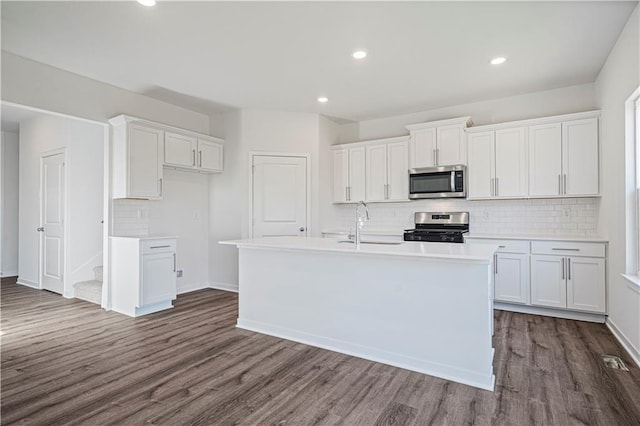 kitchen featuring stainless steel appliances, dark hardwood / wood-style floors, and white cabinets