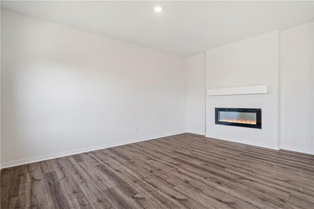 unfurnished living room featuring wood-type flooring