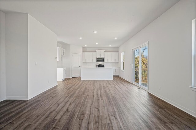 unfurnished living room featuring dark hardwood / wood-style floors