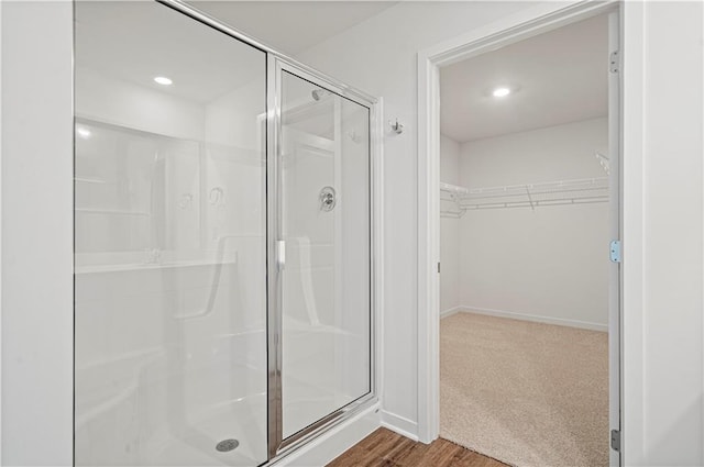 bathroom featuring hardwood / wood-style flooring and walk in shower