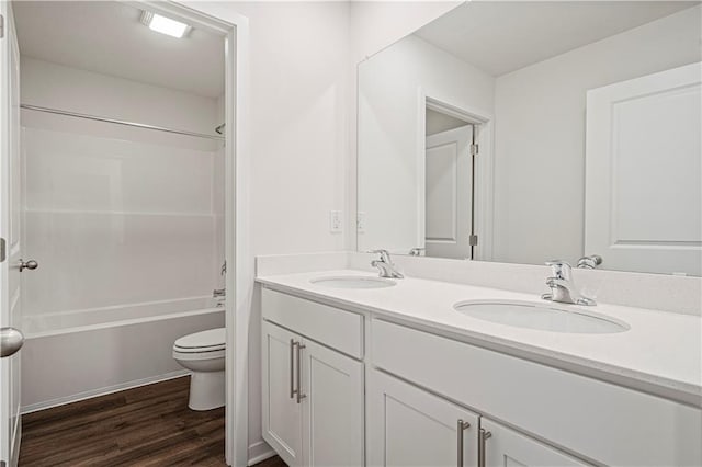 full bathroom featuring vanity, hardwood / wood-style flooring, toilet, and tub / shower combination