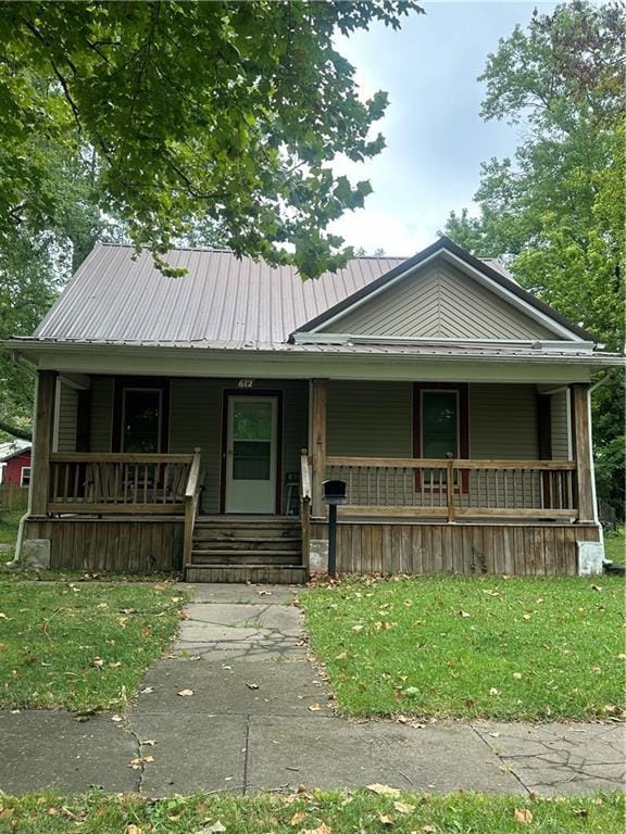 view of front of home with a front yard and a porch