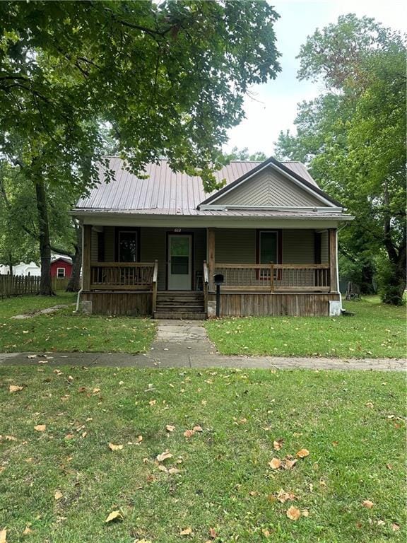 bungalow with a front yard and a porch