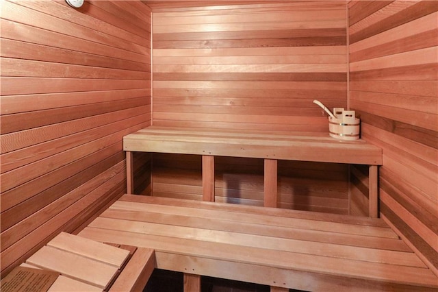 view of sauna with wooden walls