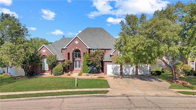 view of front of home with a garage and a front lawn