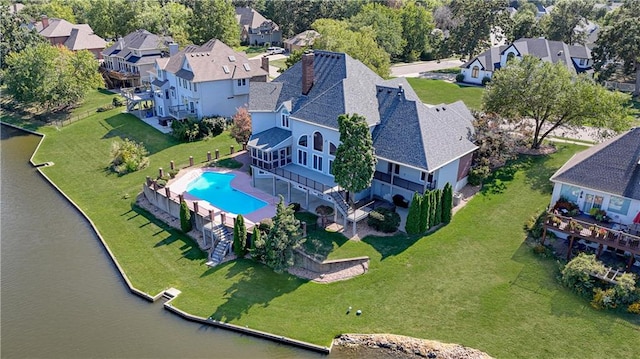 birds eye view of property with a water view and a residential view