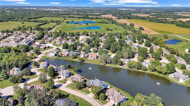 birds eye view of property with a water view and a residential view