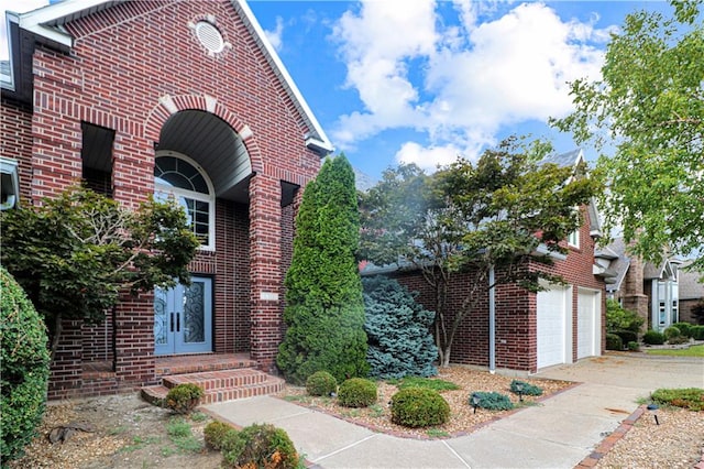 view of side of property featuring concrete driveway and brick siding