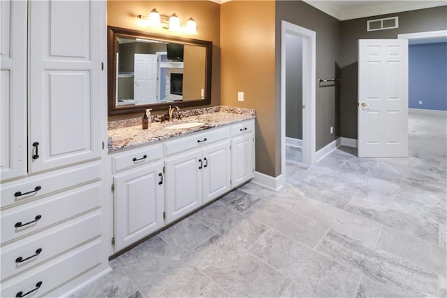 bathroom with crown molding and vanity