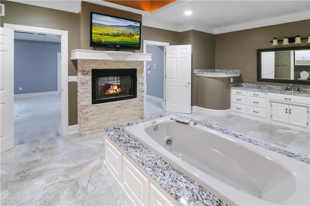 bathroom with visible vents, baseboards, a jetted tub, vanity, and a multi sided fireplace