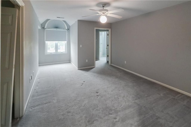 empty room featuring carpet, baseboards, and a ceiling fan