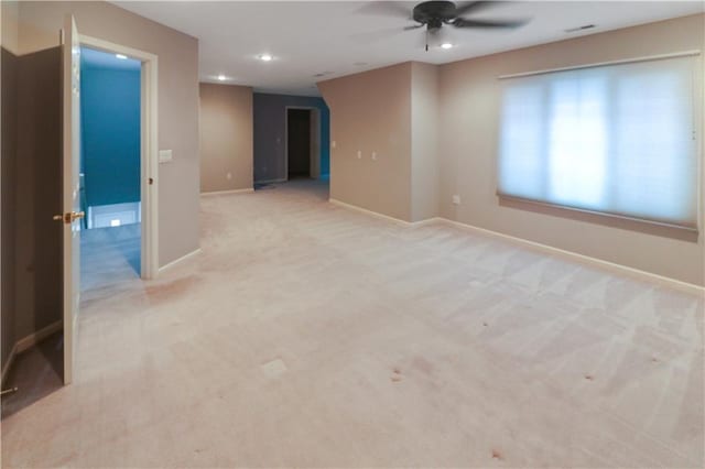 spare room featuring recessed lighting, baseboards, visible vents, and light colored carpet