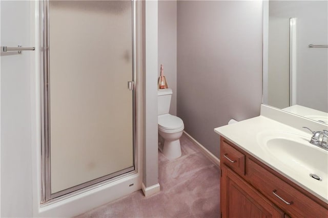 bathroom with toilet, a stall shower, baseboards, and vanity