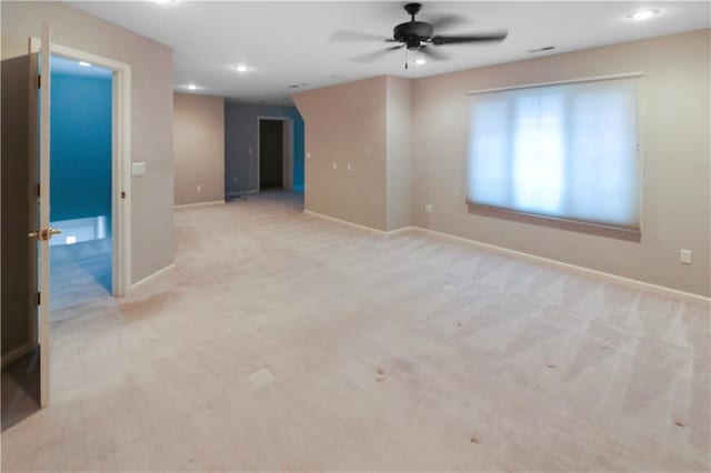 carpeted empty room featuring ceiling fan