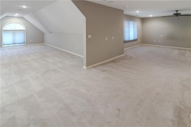 additional living space with ceiling fan, lofted ceiling, recessed lighting, light colored carpet, and baseboards