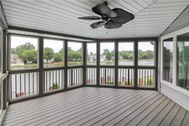 unfurnished sunroom with a water view and ceiling fan