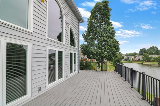 wooden terrace featuring a water view