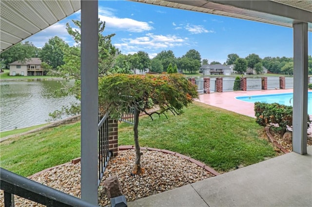 view of yard with a water view and a patio