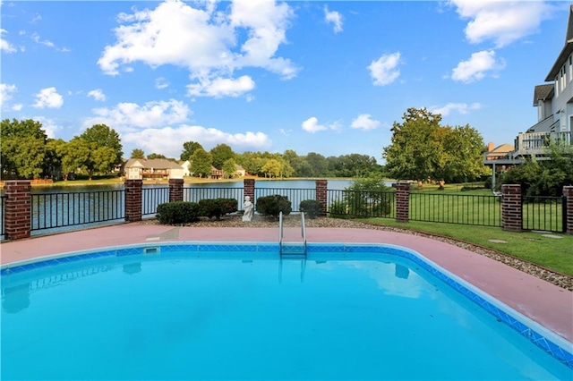 view of swimming pool with a yard, a water view, fence, and a fenced in pool