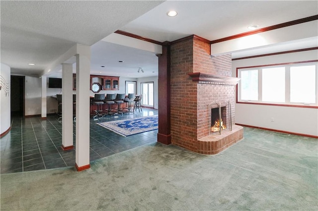 carpeted living room with a fireplace and a textured ceiling