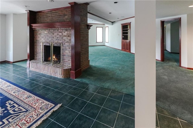 unfurnished living room with baseboards, a brick fireplace, tile patterned floors, carpet, and decorative columns