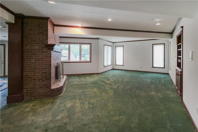 unfurnished living room with a textured ceiling, crown molding, dark colored carpet, and a brick fireplace