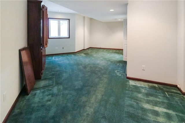 unfurnished room with dark colored carpet