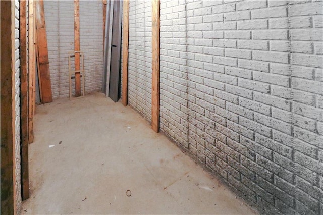 basement featuring brick wall