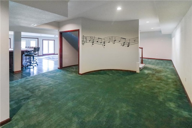 spare room featuring carpet floors, recessed lighting, baseboards, and tile patterned floors