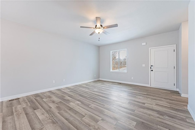 spare room with ceiling fan and light wood-type flooring