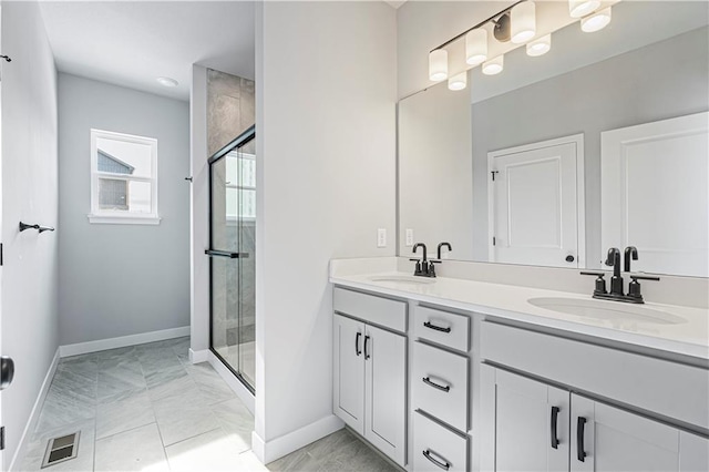 bathroom with vanity and a shower with shower door