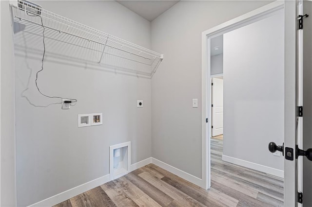 laundry room featuring electric dryer hookup, hookup for a washing machine, and light wood-type flooring