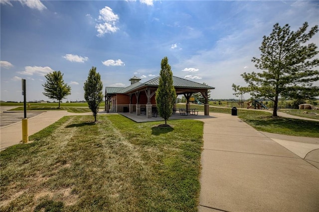 surrounding community with a gazebo and a yard