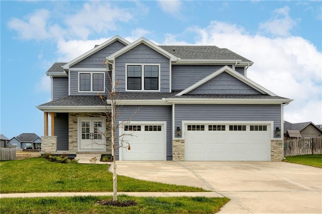 craftsman-style home featuring a garage, a front lawn, and a porch