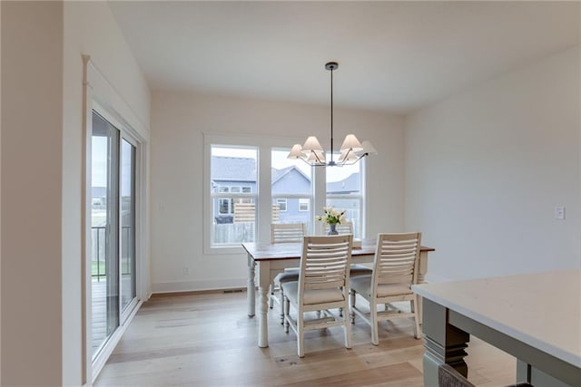 dining room with a notable chandelier and light hardwood / wood-style flooring