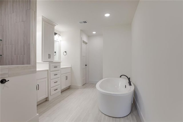 bathroom featuring vanity and a bathing tub