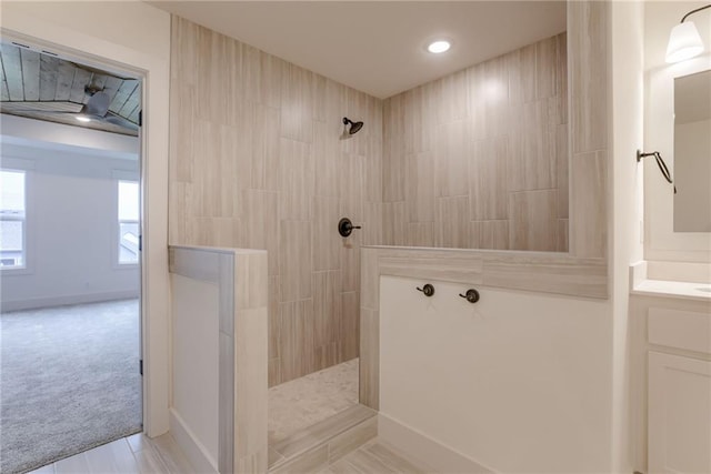 bathroom featuring vanity and tiled shower