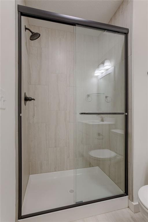 bathroom with toilet and walk in shower