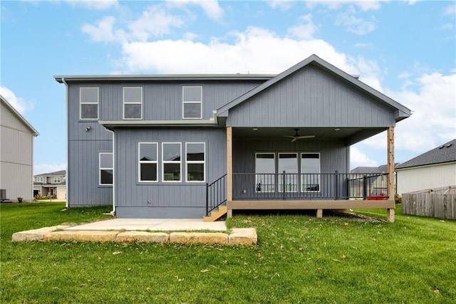 back of property with ceiling fan, a yard, and a patio area