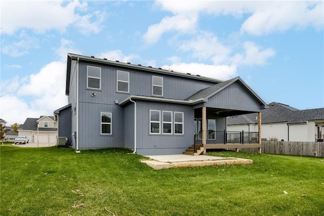 rear view of house with a yard, central AC unit, and a patio area