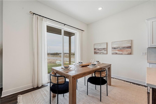 dining room with dark hardwood / wood-style flooring