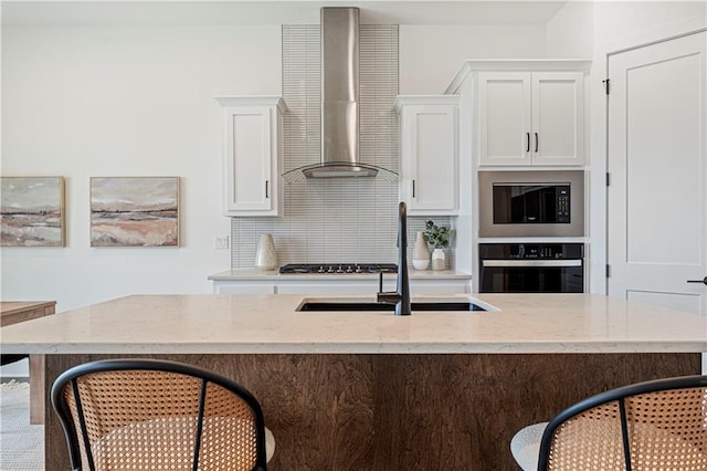 1602 NW 104th Ter, Kansas City, MO 64155 - kitchen with a kitchen bar, a sink, black oven, wall chimney exhaust hood, and stainless steel microwave