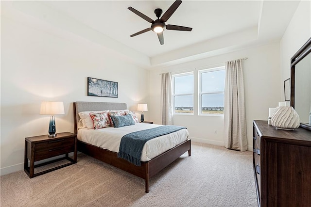 1602 NW 104th Ter, Kansas City, MO 64155 - bedroom with a tray ceiling, light colored carpet, baseboards, and a ceiling fan