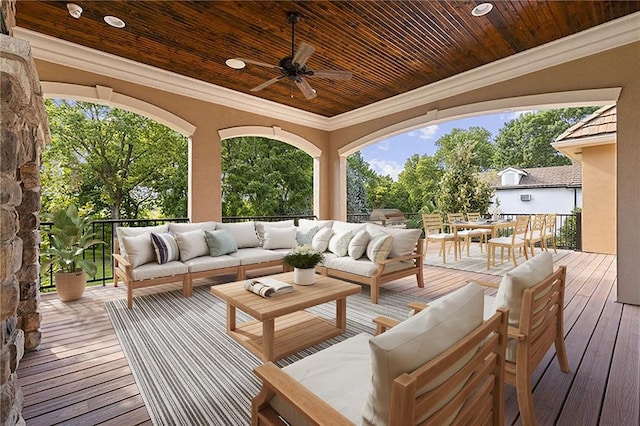 wooden terrace featuring outdoor lounge area and ceiling fan