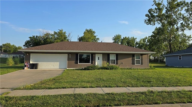 ranch-style house with a garage and a front lawn