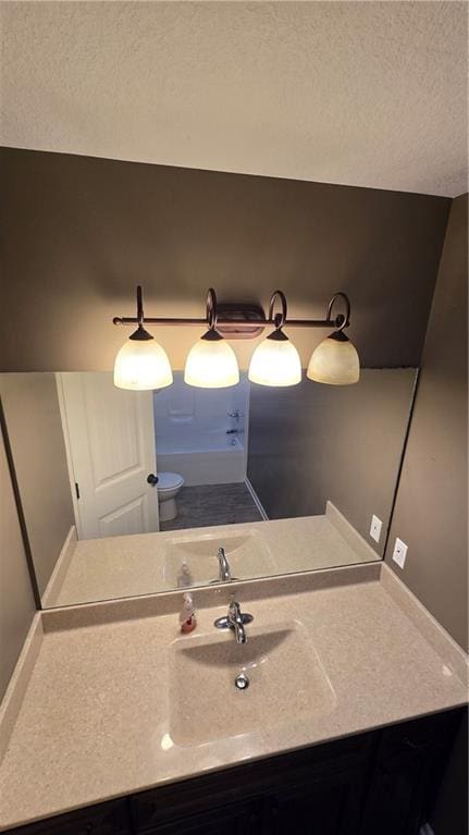 bathroom with vanity and a textured ceiling