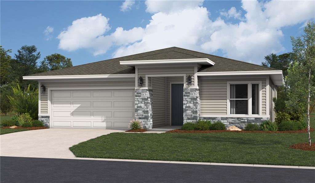 view of front of home with a front lawn and a garage