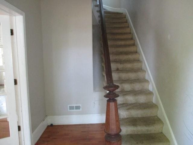 staircase featuring hardwood / wood-style floors