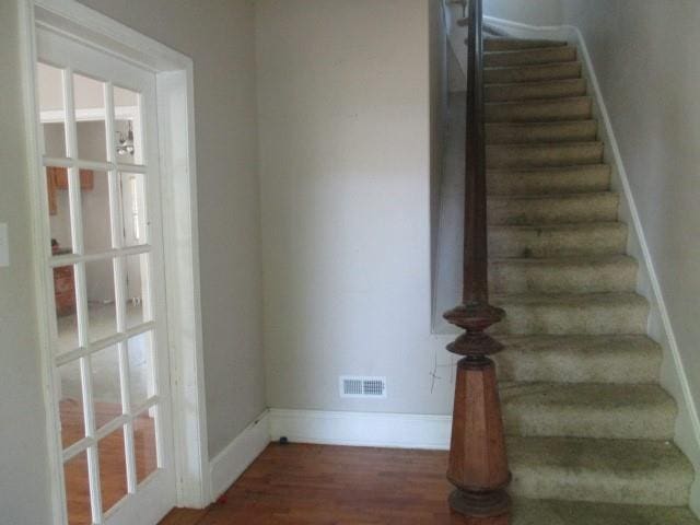 stairway featuring hardwood / wood-style floors